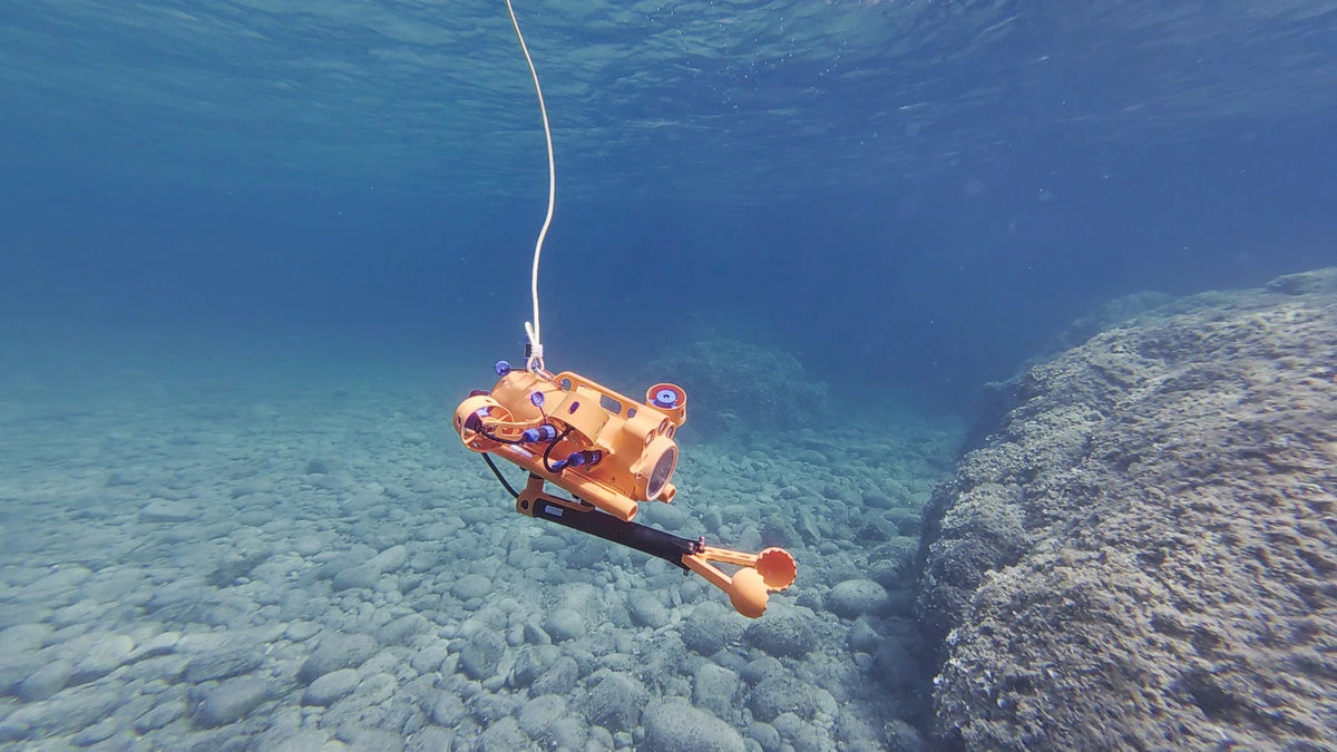 Pince robotique d’un drone sous-marin BentiX au-dessus d’un fond de galets